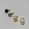 Pearl on sparkling golden spoon